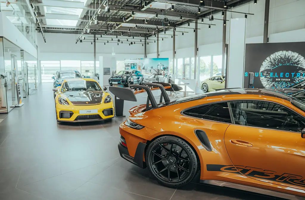 New cars in a modern showroom, illustrating automotive translation services for global markets.