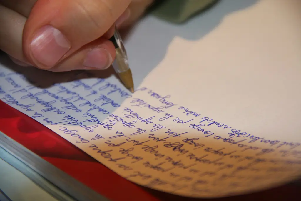 Editor marking corrections on a printed page with a red pen, showing what copyediting services cover before publishing.
